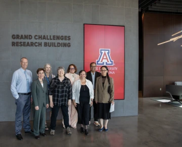 research team in front of the grand challenges research building